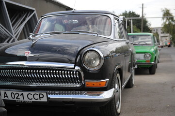 Classic Soviet cars like the Volga and Moskvich parked on Almaty streets, capturing Almaty’s vintage vibes and its rich Soviet-era history.