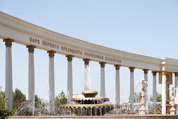 The First President's Park in Almaty, Kazakhstan, featuring a grand colonnade, a beautiful fountain, and lush greenery, a highlight of the Almaty City Tour.