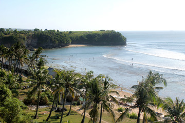 Balangan Beach in Bali is a serene escape with golden sands, stunning cliff-top views, and rolling waves, making it a paradise for surfers and nature lovers.