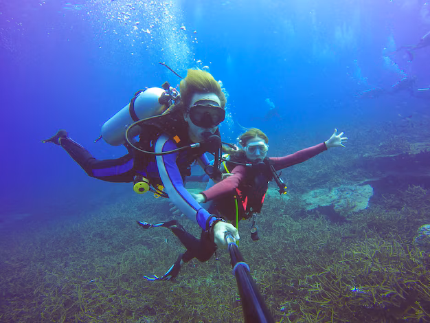 Best activities to do on your Bali honeymoon - couples enjoying a thrilling scuba diving experience in Bali's crystal-clear waters